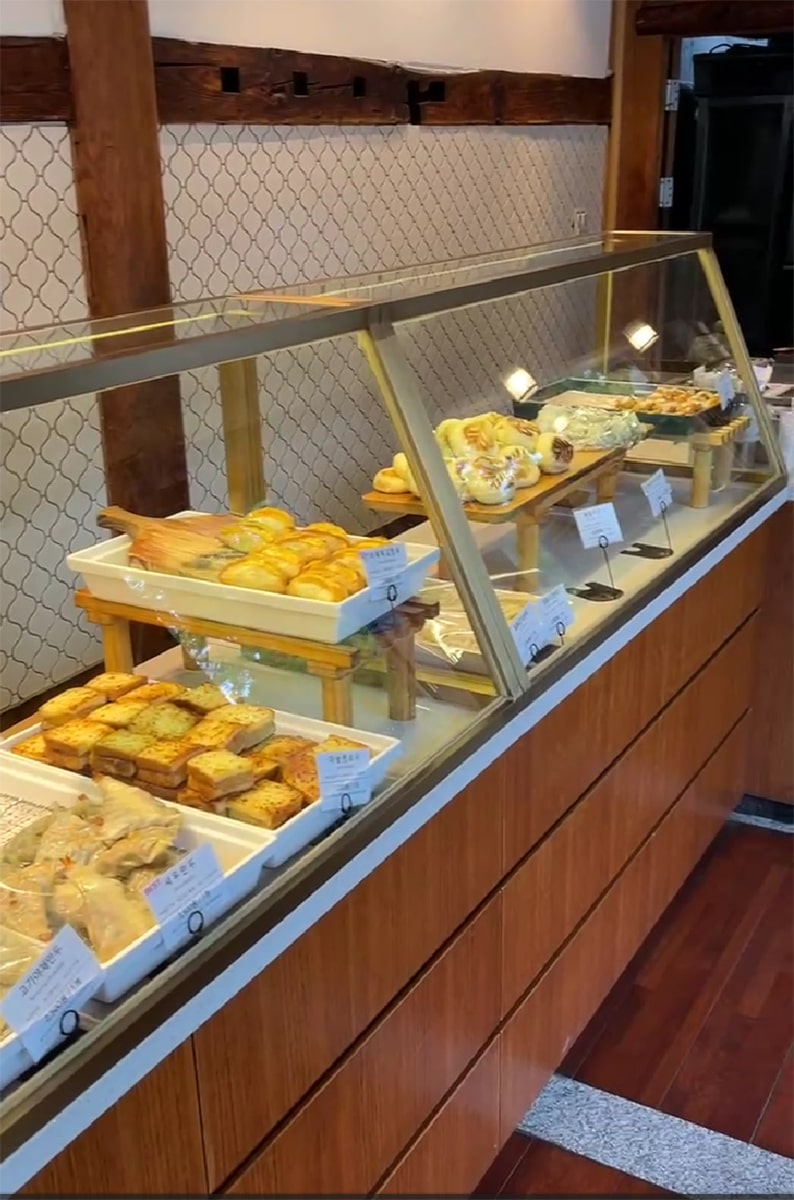various dumplings behind a counter inside a restaurant