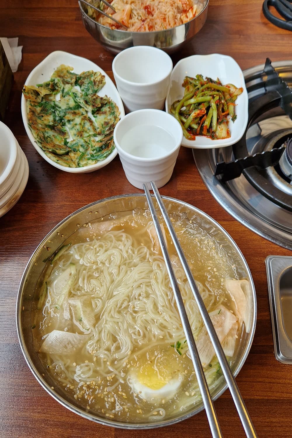 mul-naengmyeon dish and banchan seen from above
