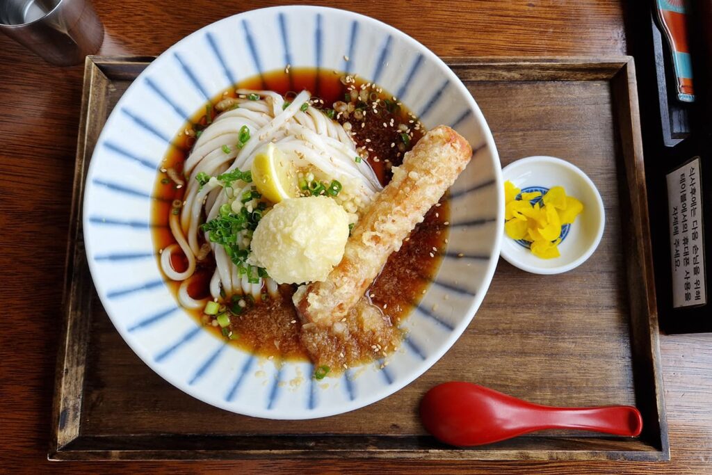 Ramen dish in a bowl on a wooden tray seen from above