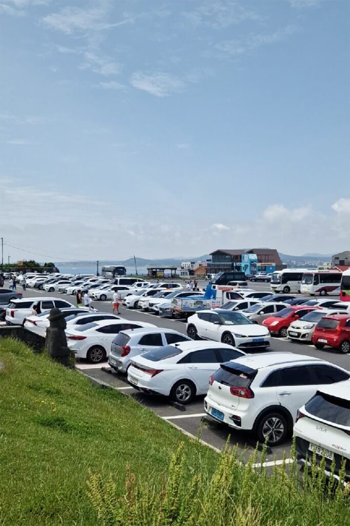 parking near seongsan ilchulbong with many white cars in it