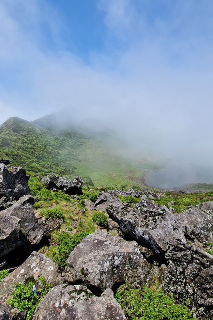 crater lake of Mt. Hallasan, partially covered by clouds