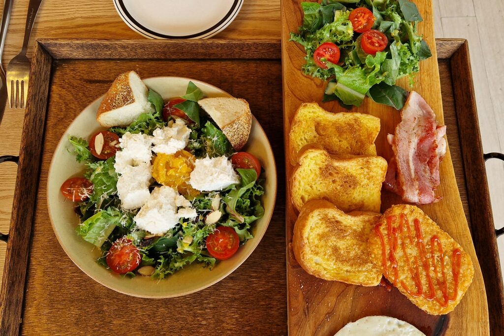 mozzarella salad and french toast on a wooden tray seen from above