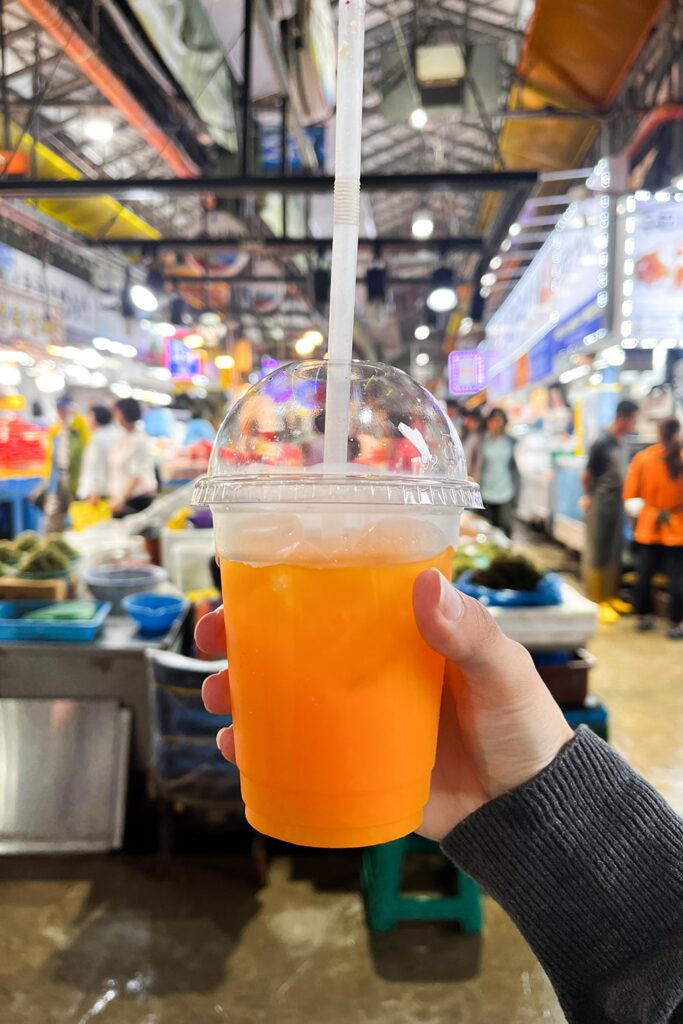 hand holding tangerine juice