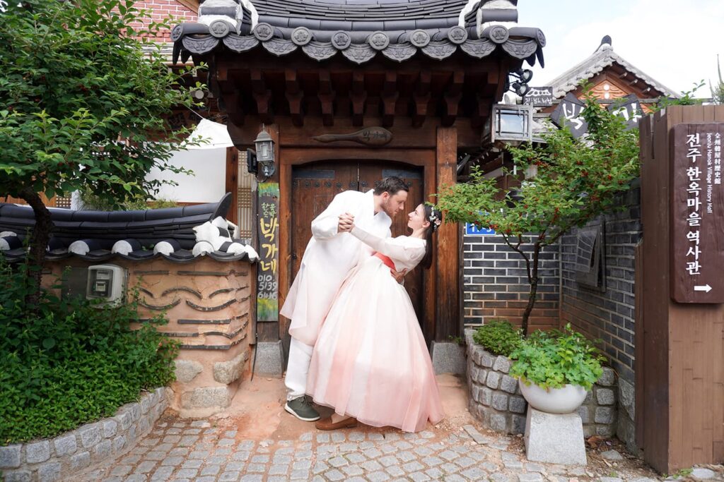 A couple taking a photoshoot while wearing tradional korean clothes named hanbok.