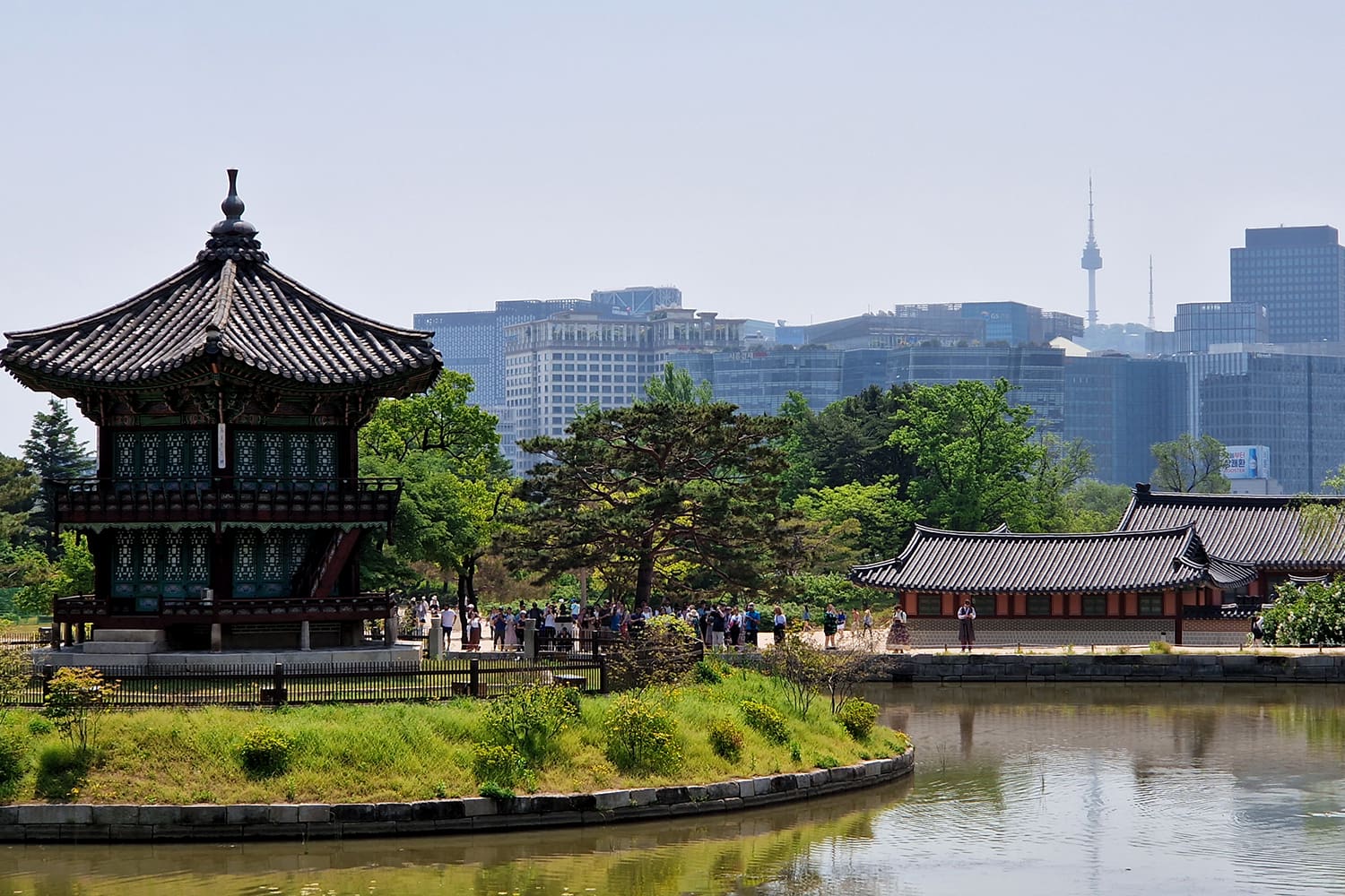 A beautiful old temple with new and modern skyscrapers in the background.