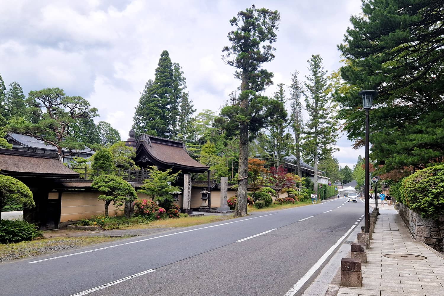 street with pedestrian walkway lined with traditional Japanese houses