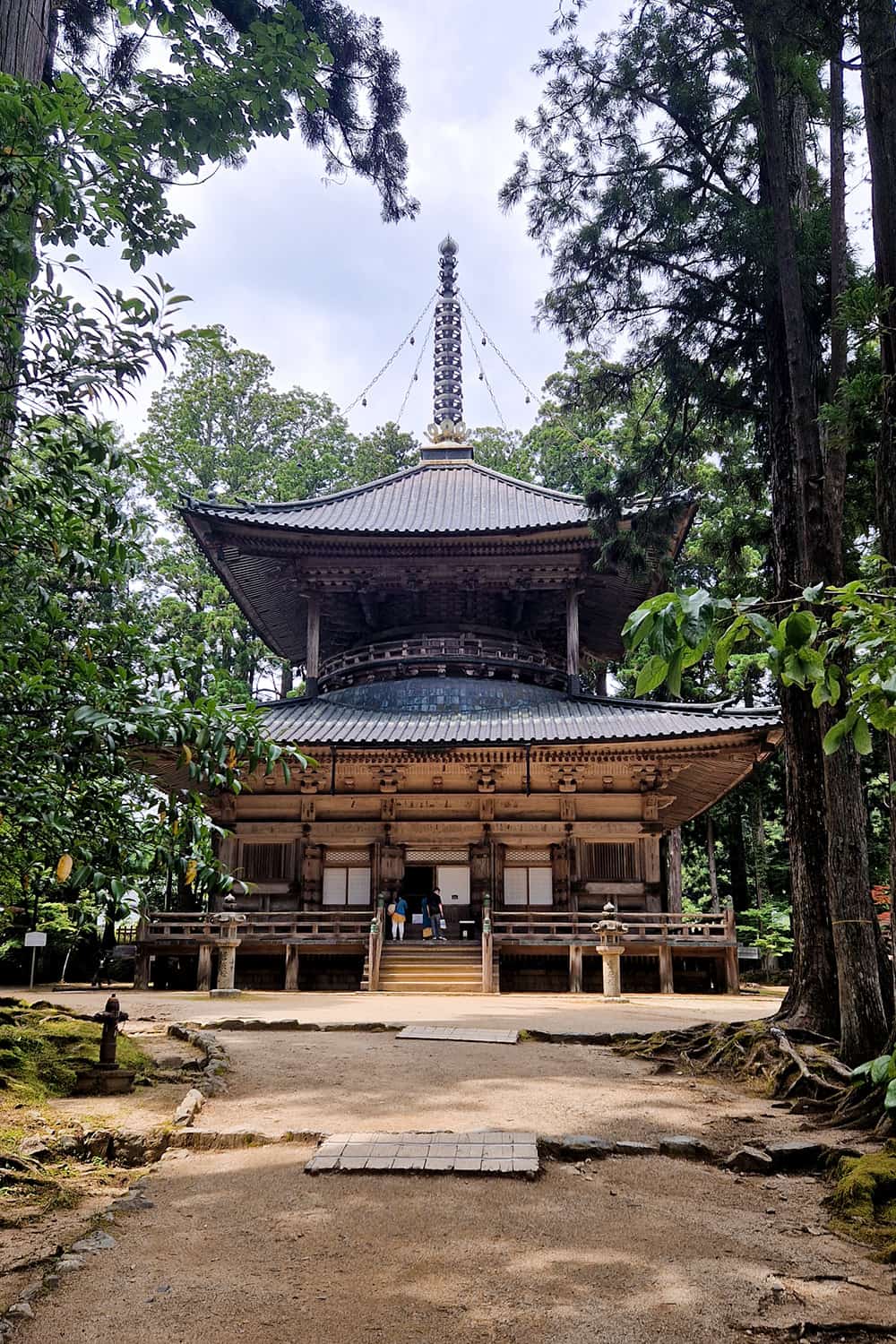 wooden Buddhist temple tower surrounded by forest