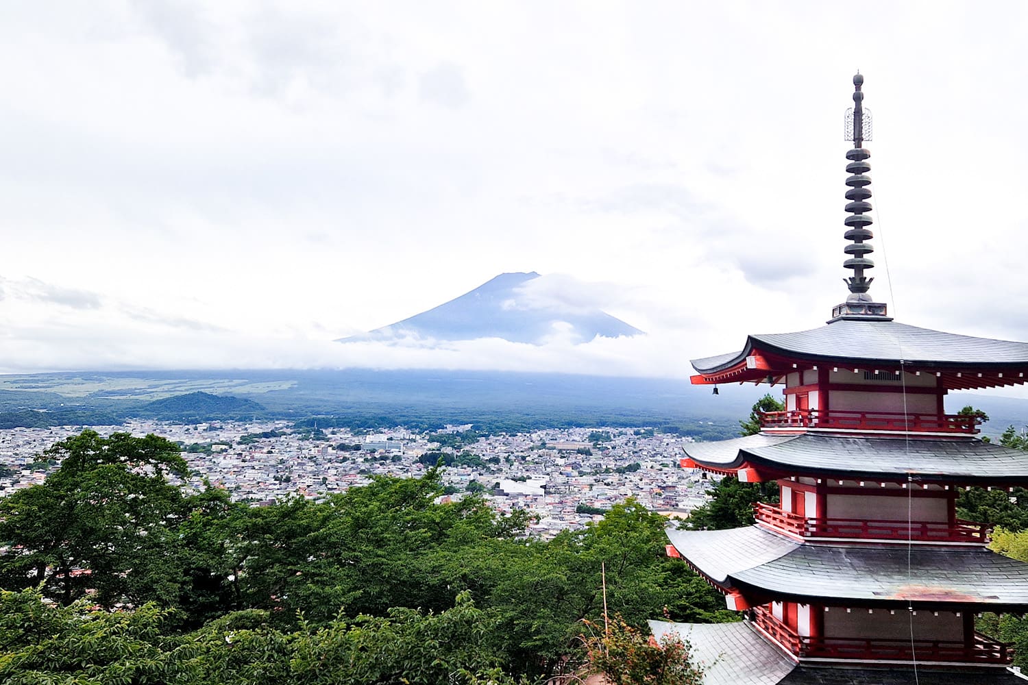 Japans famous chureito pagoda with mount fuji towering in the background. 