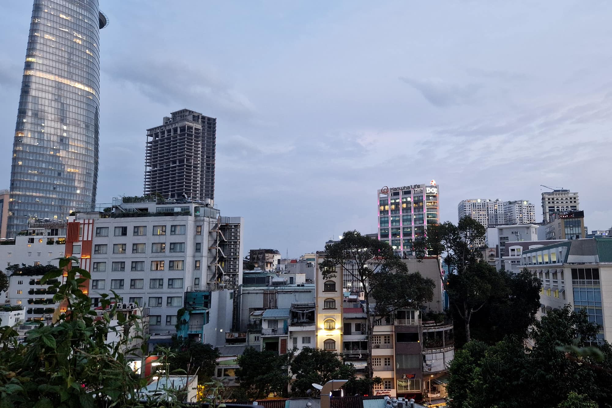 small Skyline in Ho-Chi-Minh City with a skyscraper on the left and smaller but still tall buildings on the right.