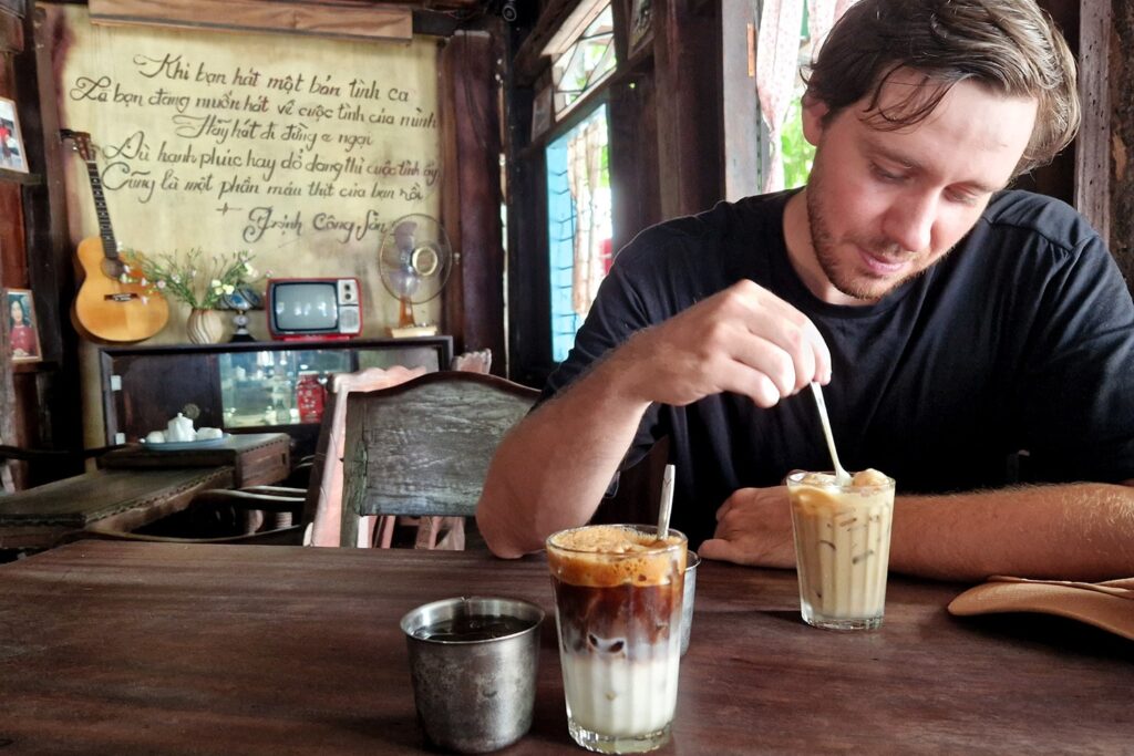 Man stirring in his Coconut Coffee in Vietnam.