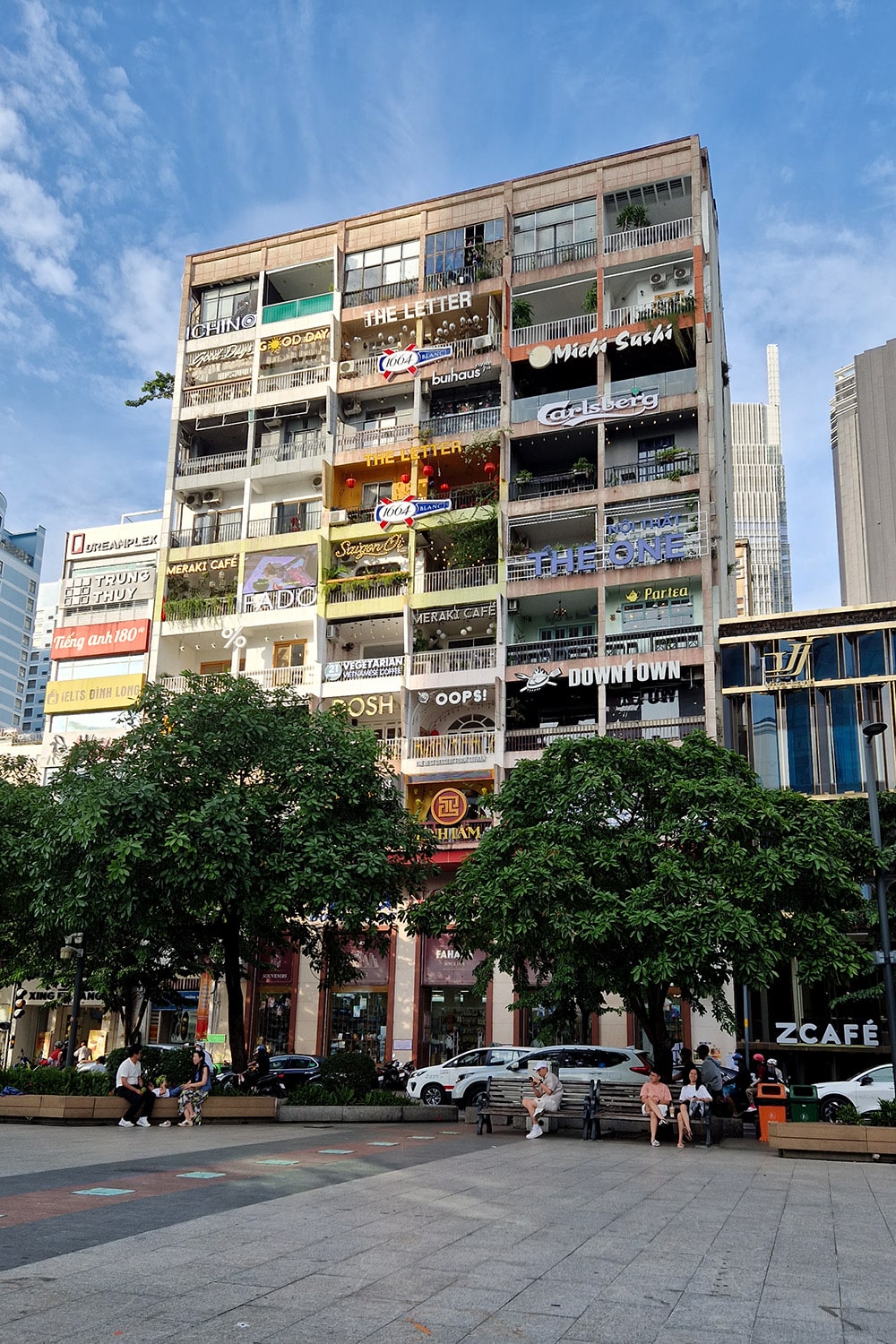 Famous building in Ho-Chi-Minh CIty with cafes and restaurants and a lot of ads for the cafes hanging on all the balconys