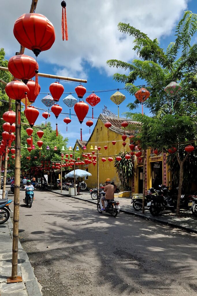 A street in hoi an decorated with red lanterns.