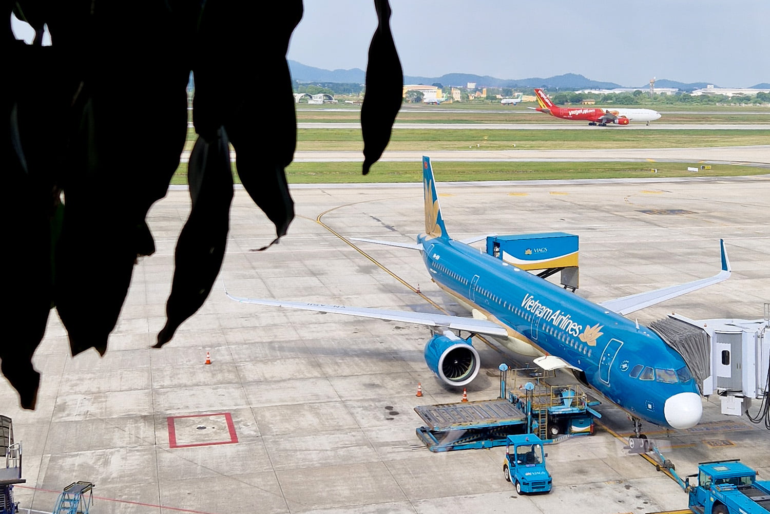 View of a Vietnam Airlines plan standing at the terminal in Hanoi Airport.