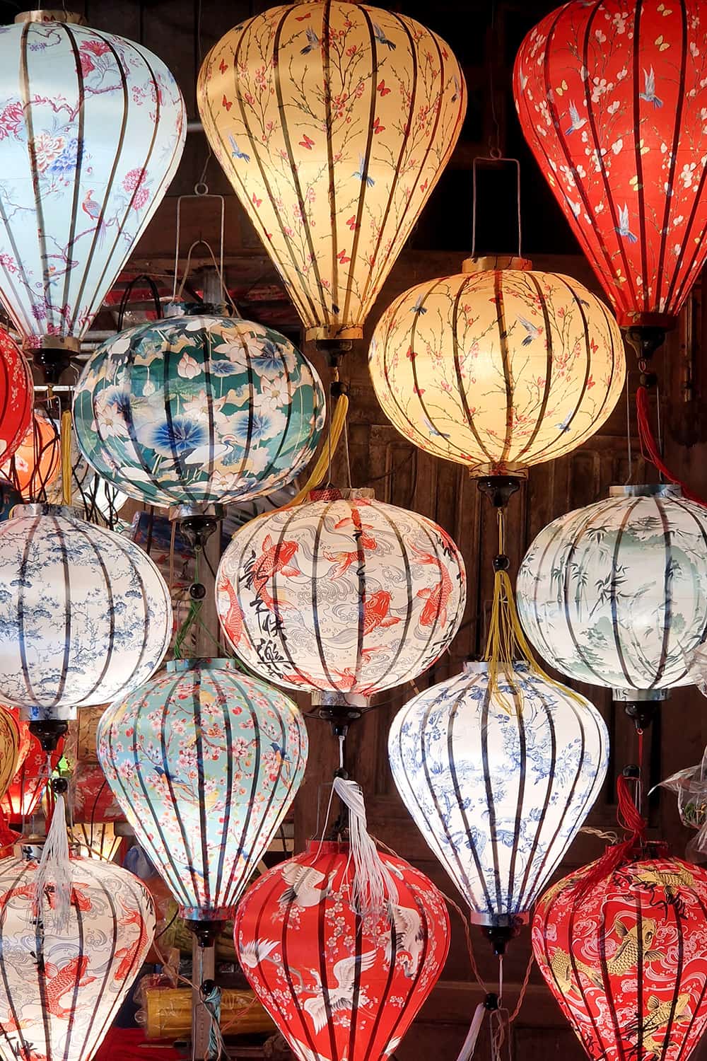 A lot of different coloured and decorated selfmade lanterns.