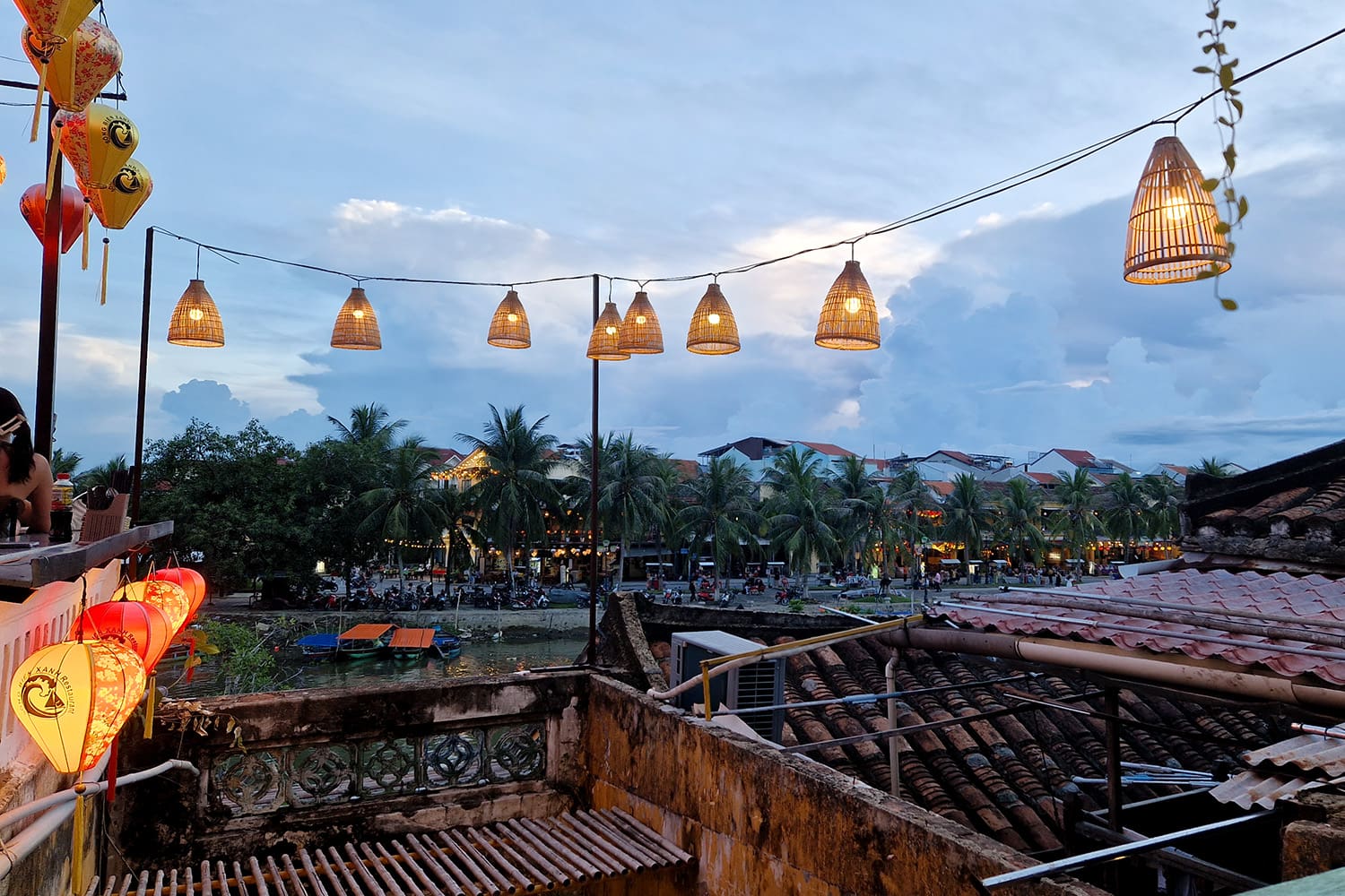 a small, with lantern decorated, rooftop bar on a third floor overlooking the canal in Hoi An.